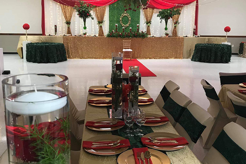 Red, green, and gold tablescape with floating candles